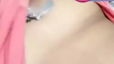 Pretty Desi woman lifts pink top to show boobs during the porn video call