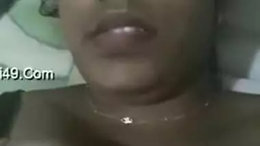 Indian aunty with sexy full lips takes big natural boobs out in bed
