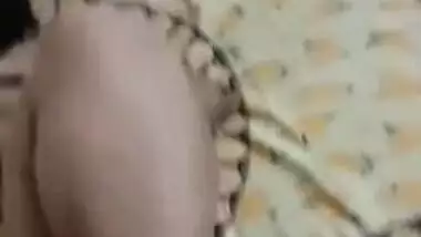 Desi woman lies in bed with legs spread while man touches XXX parts