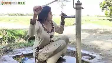 Young village school girl taking a bath in a sari and caught on camera