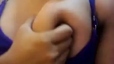 Wife in a blue sex bra takes a XXX Indian tit out and squeezes it