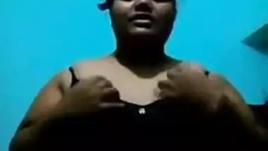 Mature Desi in a red sari exposes her big sex parts in a XXX show