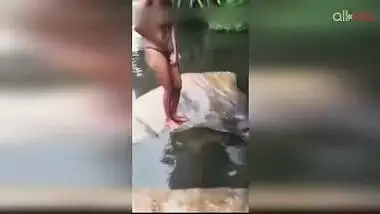 Lewd amateur Desi aunty flashing her nice big tits while bathing outdoor