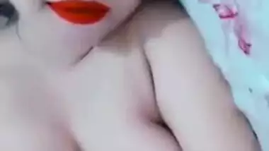 Lovely Desi with bright-red lipstick lies in bed with naked XXX parts