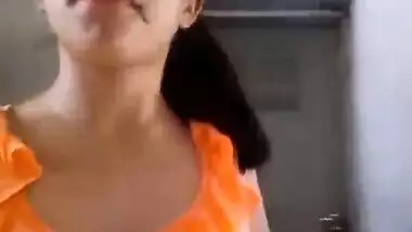 Indian babe in orange takes clothes off to flaunt boobs and buttocks