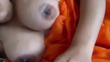 Indian MILF rubs her boobs and creams them lying in the bed in porn clip