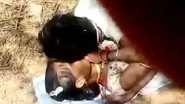 Guy lies on top of Desi girlfriend in front of XXX cameraman outdoors