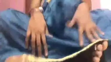 Amateur porn video where Desi MILF lifts blue dress to play with pussy